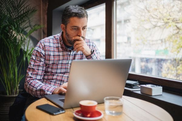 Small business owner checking email on computer Security System CCTV Camera Operator